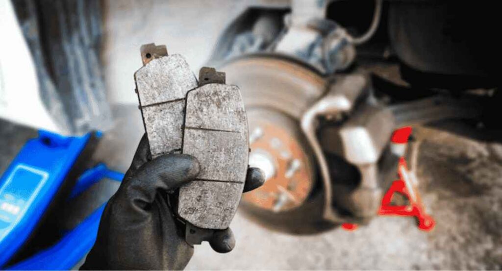 mechanic has brake pads in his hands